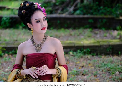 Beautiful Thai girl in traditional dress costume in Choeng Tha as Thai temple where is the public place, Thai Woman in Traditional Costume of Thailand. 