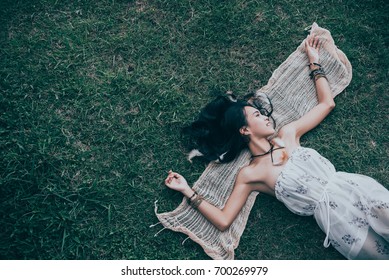 Beautiful thai woman lie on the lawn vintage style,asian girl in bohemian style