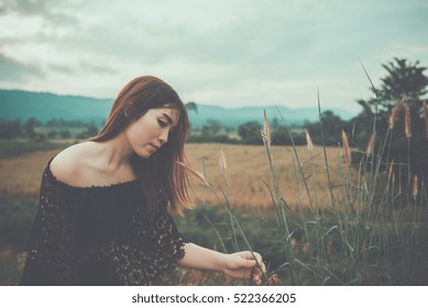 Beautiful Thai Woman Use Hand Touch Flower Grass,very Sad From Unrequited Love,rethink,think Over,vintage Style,dark Tone,broken Heart,asian Girl