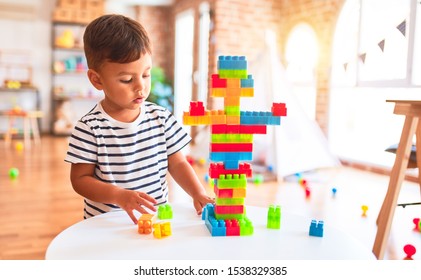 Beautiful Toddler Boy Playing With Construction Blocks At Kindergarten