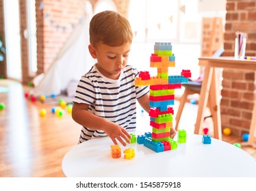 Beautiful Toddler Boy Playing With Construction Blocks At Kindergarten