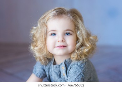 Portrait Of A Little Baby With Blond Hair And Blue Eyes Images