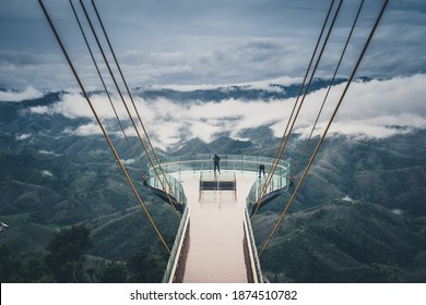 Beautiful top view of sea of fog at Ai Yerweng Skywalk in Yala province, the longest skywalk in Asia. Tourists visit the landmark above forest during sunrise.