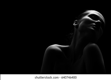 beautiful topless woman with closed eyes on black background monochrome