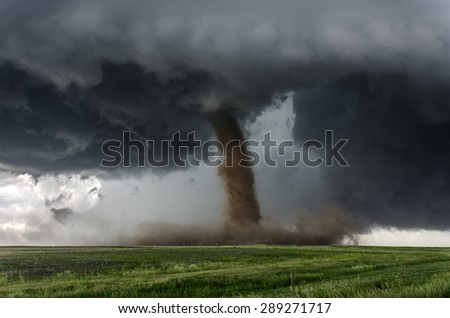 Beautiful tornado over a dusty field