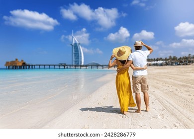 A beautiful tourist couple stands hugging on a beautiful beach in Dubai - Powered by Shutterstock