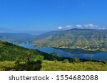 A Beautiful tourist destination, a valley with blue water river / lake, green hill / mountain on backdrop and blue sky. swituated in Panchgani mahabaleshwar, Maharashtra