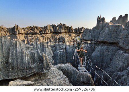 Beautiful tourist on an excursion in the unique limestone landscape at the Tsingy de Bemaraha Strict Nature Reserve in Madagascar