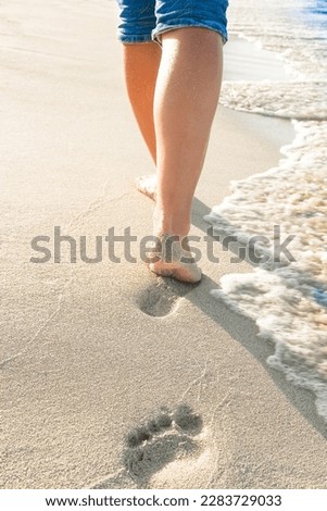 beautiful traces with feet near the sea on nature background