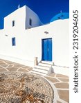 Beautiful traditional architecture of the Cyclades islands, white washed walls and blue doors and windows. Here is the chapel of Agios Ioannis Detis.