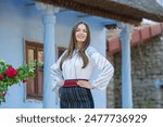 Beautiful traditional costume from Republic of Moldova. Young girl wearing Romanian traditional blouse.