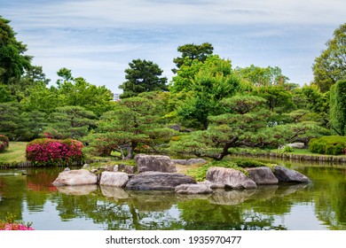 Beautiful traditional Japanese garden with lake and island, spring sunny day