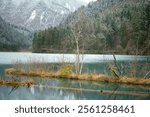 Beautiful tranquil lake view of Jiuzhaigou valley parkland with snow mountain in winter season as background. The most famous Unesco world heritage site in Sichun, China. Nature environment landscape.