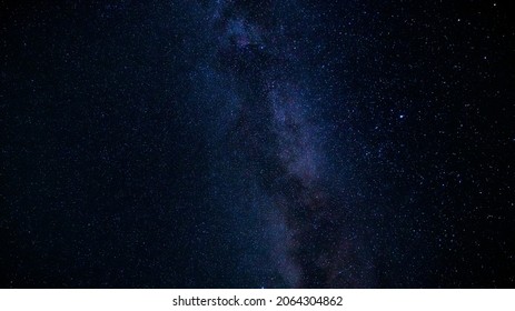 A Beautiful Tranquil Long Exposure Photograph Of The Milky Way With Millions Of Glowing Stars On A Clear Summer Night In The Mountains While Stargazing.