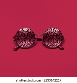 Beautiful trendly sunglasses and leopard pattern New 2023 trending PANTONE 18  1750 Viva Magenta color