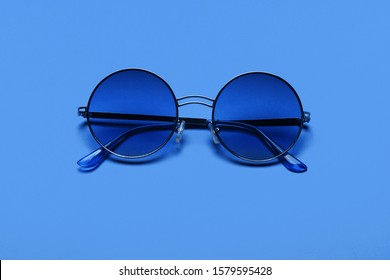 Beautiful trendly sunglasses on a Classic Blue Pantone color of the year background
