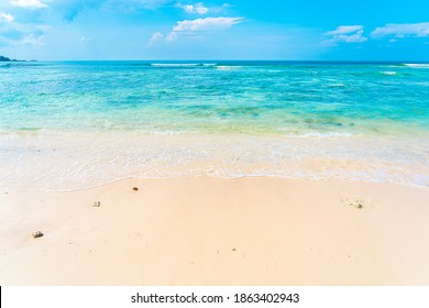 Beautiful tropical empty beach sea ocean with white cloud on blue sky background for leisure travel vacation - Shutterstock ID 1863402943
