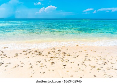 Beautiful tropical empty beach sea ocean with white cloud on blue sky background for leisure travel vacation - Shutterstock ID 1863402946