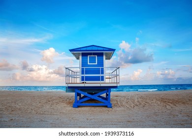 Beautiful tropical Florida landscape with blue lifeguard house at sunset twilight. American beach ocean scenic nature view with lifeguard tower. Beautiful sky on sunrise. Summer seasonal background. - Powered by Shutterstock