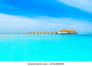 Beautiful tropical landscape with wooden water villas over of the Indian Ocean, Maldives island