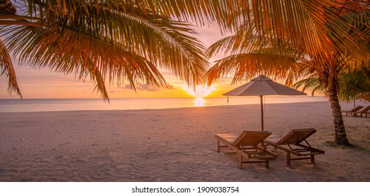 Beautiful Tropical Sunset Scenery, Two Sun Beds, Loungers, Umbrella Under Palm Tree. White Sand, Sea View With Horizon, Colorful Twilight Sky, Calmness And Relaxation. Inspirational Beach Resort Hotel