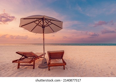 Beautiful Tropical Sunset Scenery, Two Sun Beds, Loungers, Umbrella Under Palm Tree. White Sand, Sea View With Horizon, Colorful Twilight Sky, Calmness And Relaxation. Inspirational Beach Resort Hotel