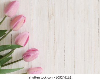 beautiful tulips on wooden background - Shutterstock ID 605246162