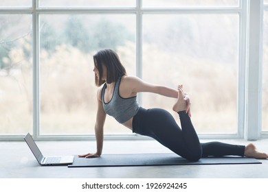 Beautiful Turkish Young Woman Attending An Online Yoga Class With Her Laptop