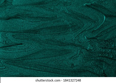 Beautiful turquoise stains of liquid nail polish,fluid art technique.Monochrome marble background.Liquid stripy paint texture.Nail laquer flow modern backdrop.Minimalistic concept.Copy space.