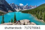 Beautiful turquoise waters of the Moraine lake with snow-covered rocky mountains in Banff National Park of Canada.