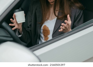 Beautiful unhappy business woman spilling coffee on shirt. Girl with stains on her clothes in the hand of a cup of coffee. concept of cleaning stains on clothes. High quality photo