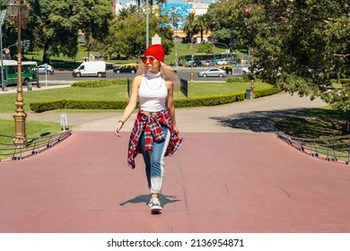 A Beautiful Urban Latina Woman Walking On A Bridge In Sunny Day