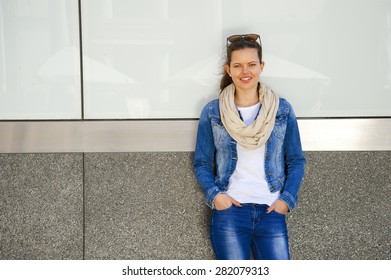 Beautiful Urban Woman, Girl Standing By The Wall In City Wearing Jeans Jacket