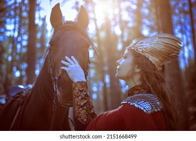 A beautiful valkyrie is talking to her horse while standing in the forest. Scandinavian mythology. Fantasy.