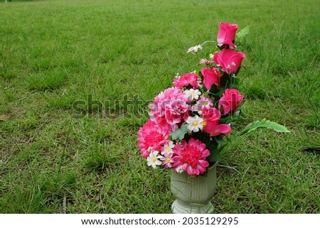 Beautiful vase of flowers on the lawn