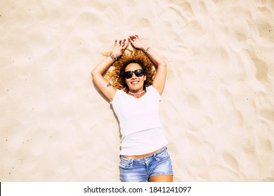 Beautiful Vertical View Of Adult Young Caucasian Woman Lay Down On The Sand At The Beach Enjoying Summer Holiday Vacation And Travel Tourism Ligfestyle Under A Warm Sun