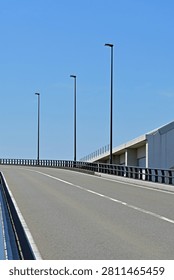 Beautiful vertical view of an empty elevated roadway and modern infrastructure under a clear blue sky, Fukushima Japan.