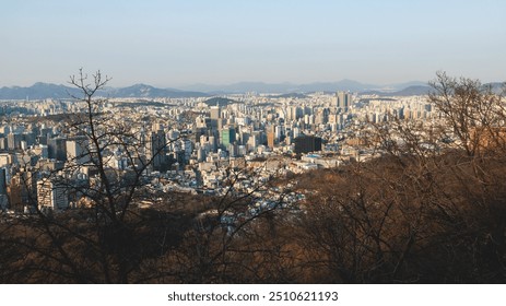 Beautiful vibrant aerial sunset view of Seoul, South Korea skyline, with mountains and sprin scenery beyond the city, seen from observation deck of Namsan Park, Gyeonggi-do province, Republic of Korea - Powered by Shutterstock