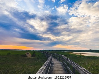 Beautiful, Vibrant Sunset Along Meadow Lane Boardwalk Near A Beach Front In Southampton, NY. 