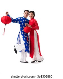Beautiful Vietnamese couple with red paper lanterns, isolated on white
