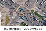 Beautiful view from above to a busy road junction in Moscow. Colorful cars and trucks driving straight forward in both directions and pedestrians crossing the road on a sunny summer day.