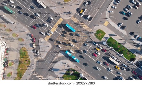 Beautiful view from above to a busy road junction in Moscow. Colorful cars and trucks driving straight forward in both directions and pedestrians crossing the road on a sunny summer day. - Shutterstock ID 2032995383