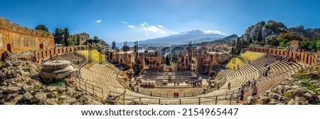 A beautiful view of the Ancient theater of Taormina with Mount Etna in the background, Sicily, Italy