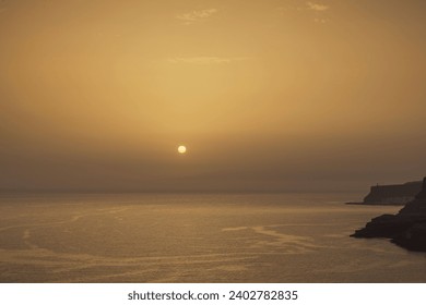 Beautiful view of the Atlantic Ocean with a yellow-orange sunset in the Canary Islands, Spain. - Powered by Shutterstock