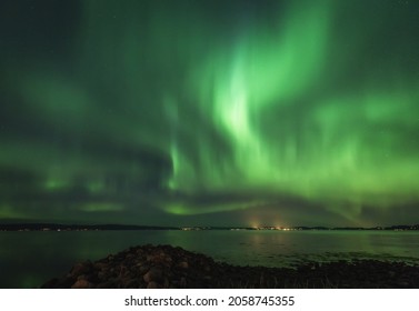 A beautiful view of the aurora borealis reflection on the lake in Lofoten, Norway