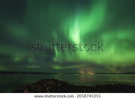 A beautiful view of the aurora borealis reflection on the lake in Lofoten, Norway