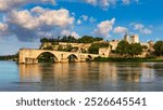 Beautiful view of Avignon with famous bridge Saint-Benezet, medieval architecture along the Rhone River in Avignon, France. The Pont Saint Benezet and the Papal palace in Avignon, South France.