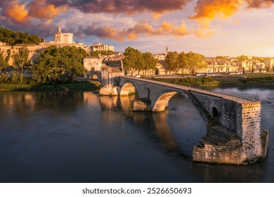 Beautiful view of Avignon with famous bridge Saint-Benezet, medieval architecture along the Rhone River in Avignon, France. The Pont Saint Benezet and the Papal palace in Avignon, South France.