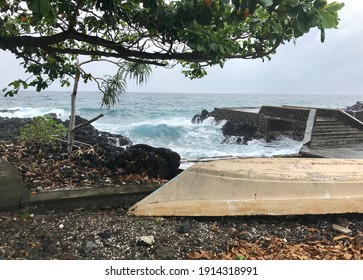 A beautiful view from the beach in Moroni Island, with a fruit tree and a fibre boat in the foreground. This beach is filled with lava rock flew from the Mout Karthala