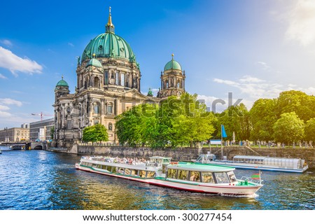 Beautiful view of Berliner Dom (Berlin Cathedral) at famous Museumsinsel (Museum Island) with excursion boat on Spree river in beautiful evening light at sunset, Berlin, Germany